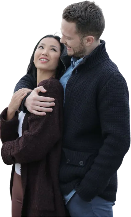 A young couple embracing and smiling at each other
